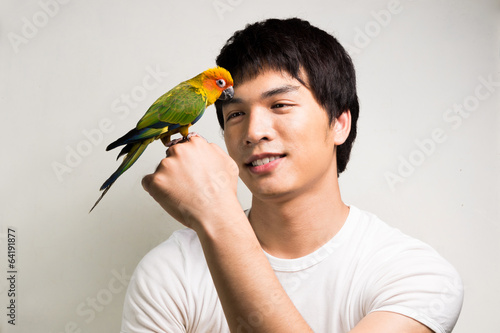 Asian men with parrot - Sun Conure photo