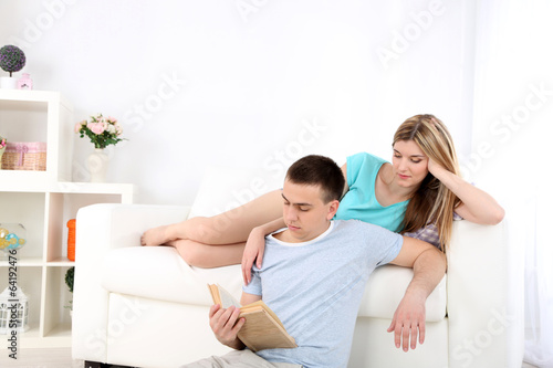 Beautiful couple reading on sofa