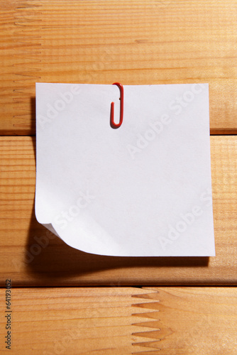 Empty paper sheet on wooden background