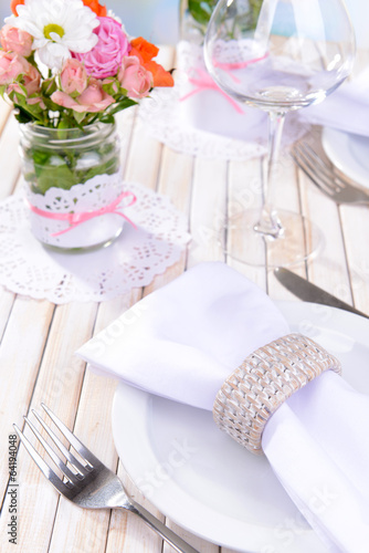 Fototapeta Naklejka Na Ścianę i Meble -  Beautiful table setting with spring flowers in jar close-up