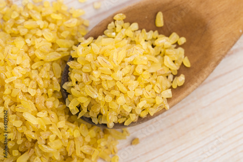 bulgur wheat in wooden spoon