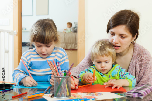 mother and children sketching with pencils