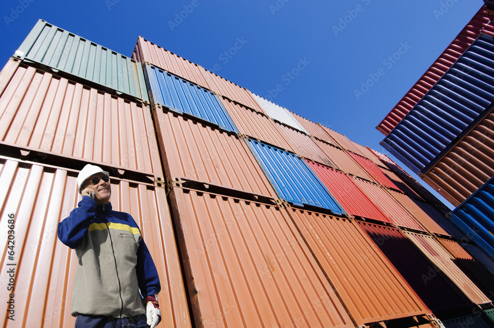 port worker with stacks of cargo containers, shipping