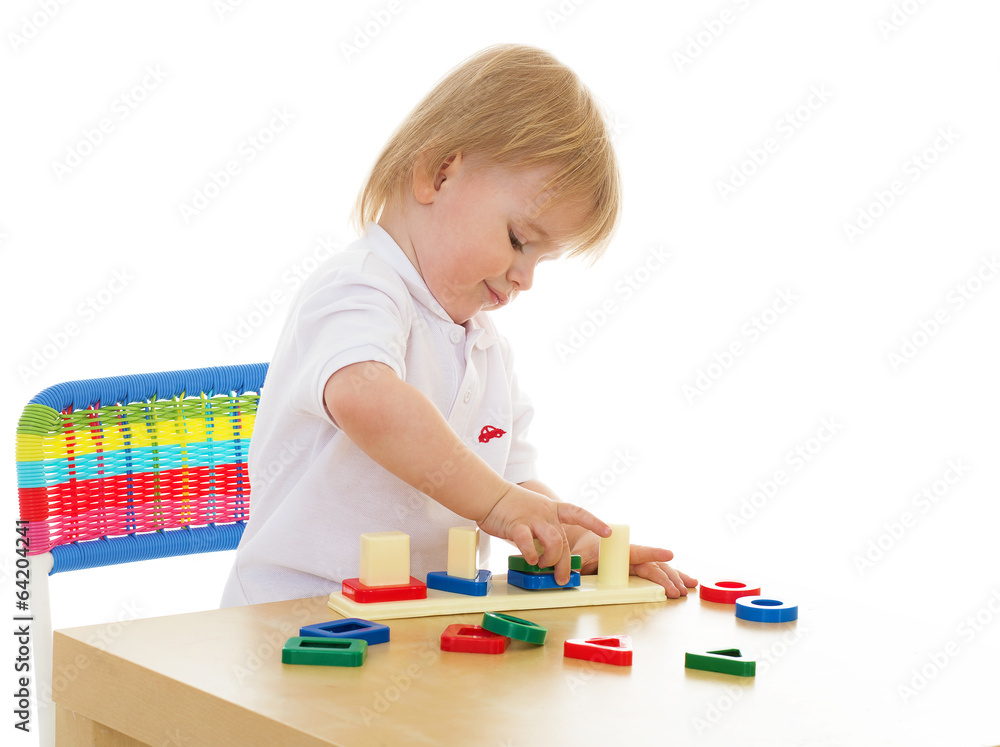 Little boy enthusiastically working with Montessori materials Little boy enthusiastically working with Montessori materials