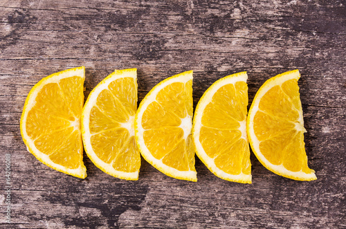 row orange slices on wood background