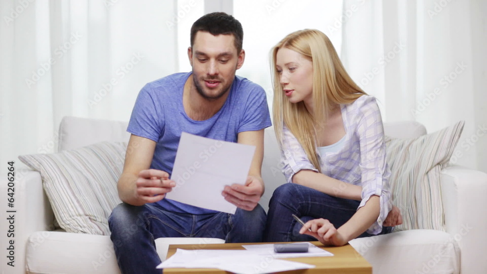 busy couple with papers and calculator at home busy couple with papers and calculator at home