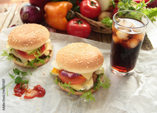Tasty hamburgers with fresh vegetables and cold cola