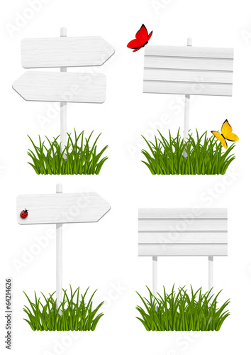 Set of wooden signboards in green grass