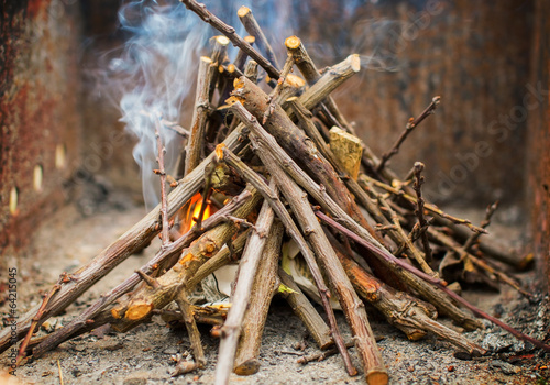 Fototapeta Naklejka Na Ścianę i Meble -  Kindling a fire with small sticks