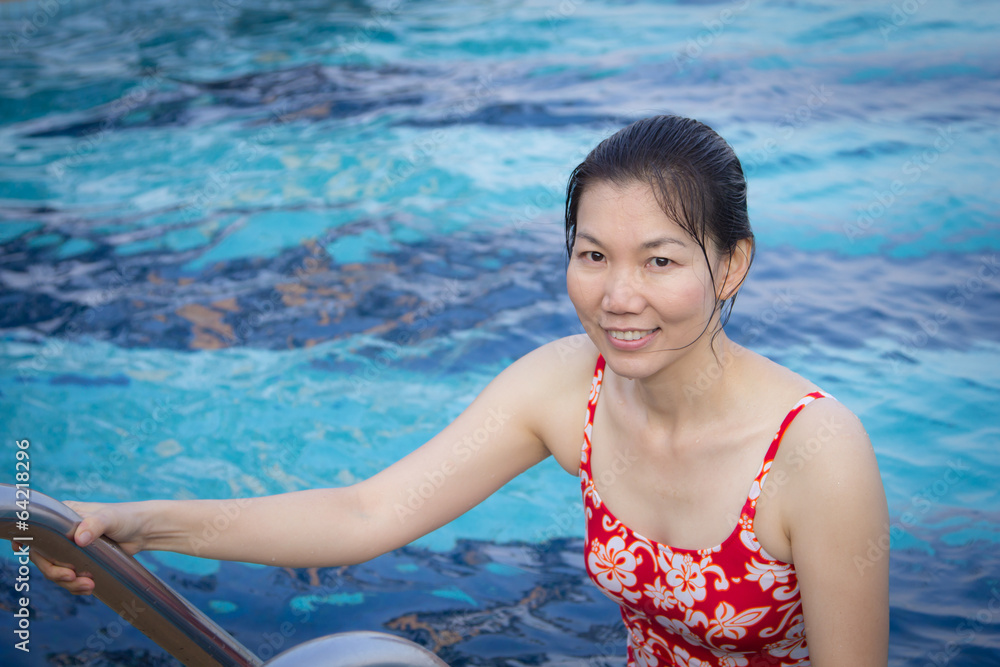 Portrait of Asian woman getting out of a swimming pool Portrait of Asian woman getting out of a swimming pool