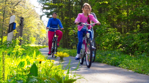 family trip on bicycles, mother with two daughter riding bikes