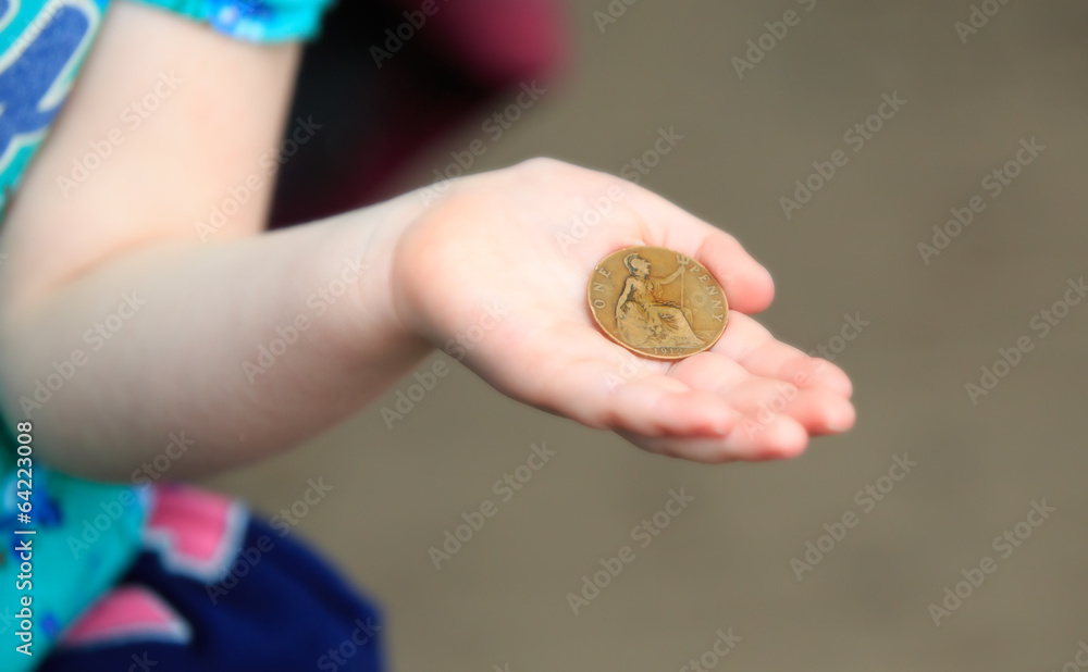 Little hand holding an old penny coin Little hand holding an old penny coin