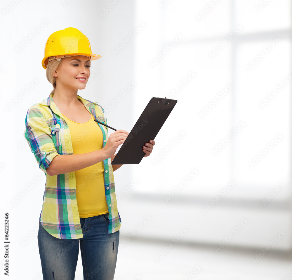 smiling woman in helmet with clipboard smiling woman in helmet with clipboard