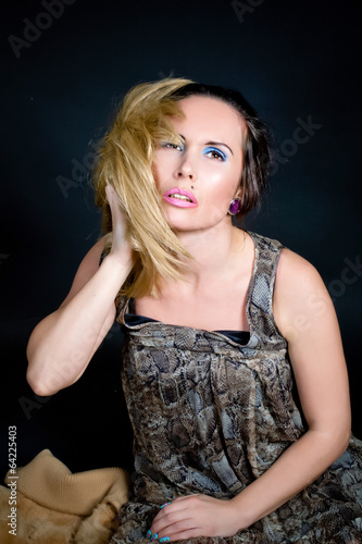 Portrait of a beautiful female model on dark background © evasilchenko