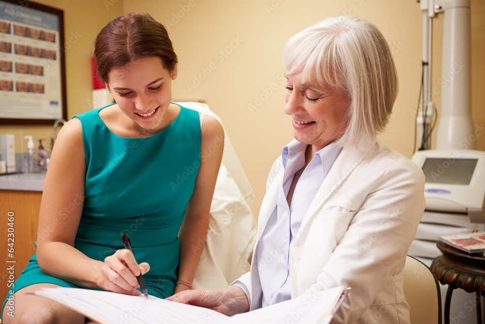 Cosmetic Surgeon Discussing Proceedure With Client In Office Cosmetic Surgeon Discussing Proceedure With Client In Office