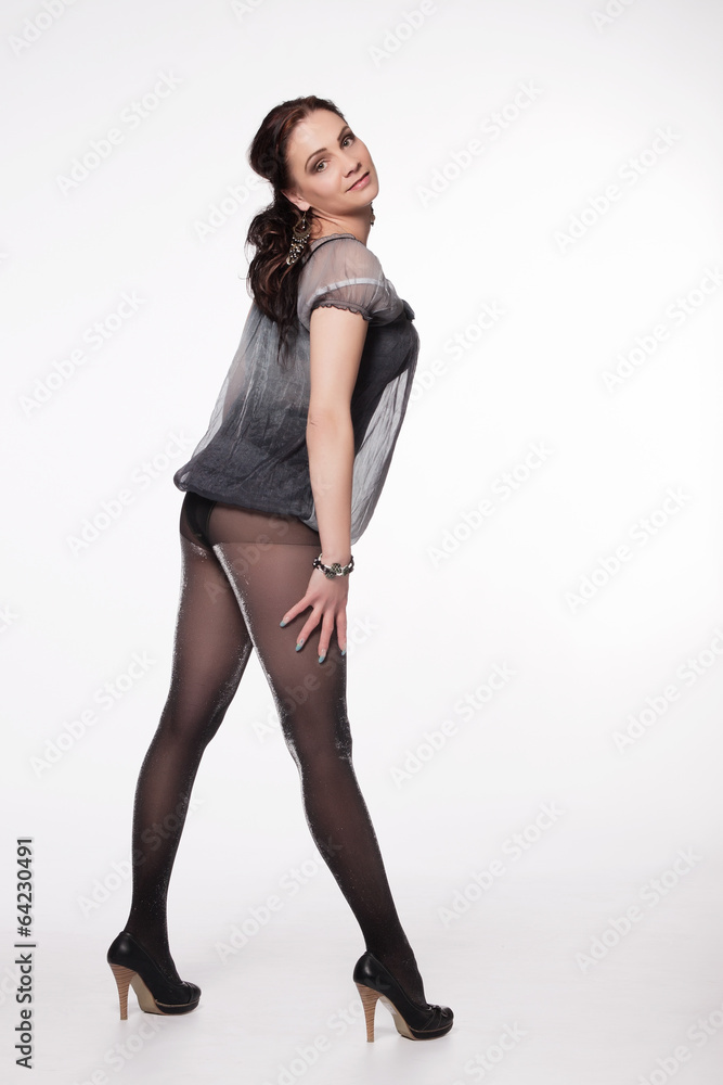 Fototapeta premium Young long-haired woman in transparent babydoll, glittering stoc