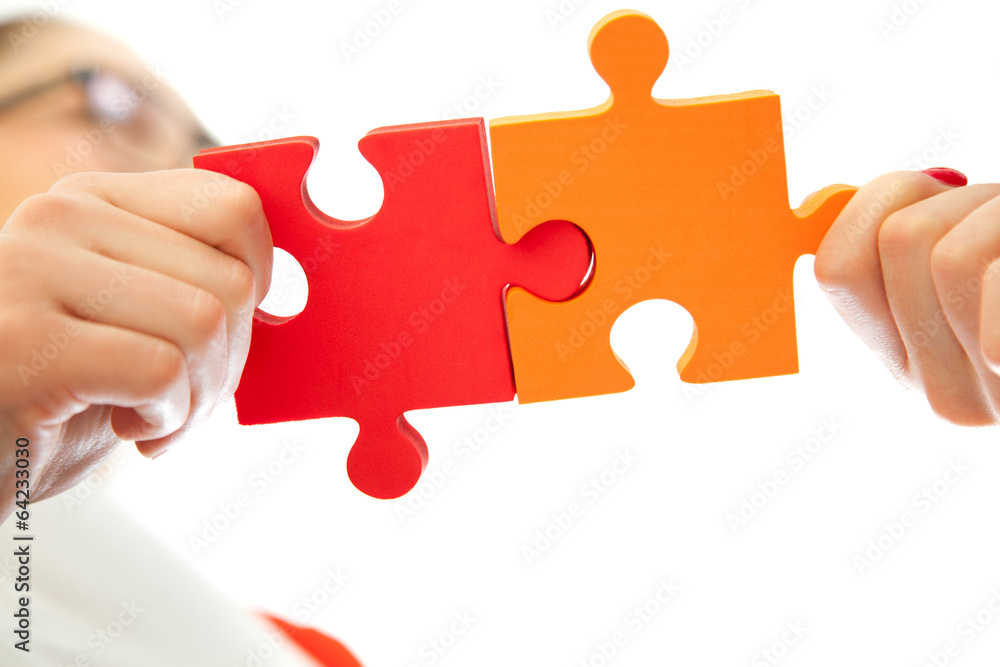 business women assembling jigsaw puzzle and business women assembling jigsaw puzzle and