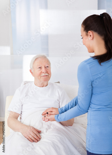 Caregiver Consoling Senior Man