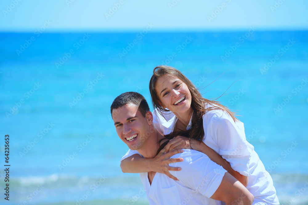 happy couple have fun on the beach happy couple have fun on the beach