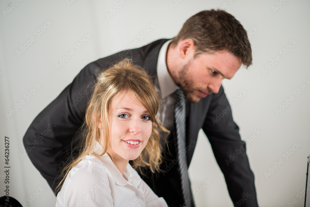 portrait of two business people working together in office portrait of two business people working together in office