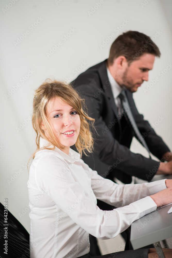 portrait of two business people working together in office