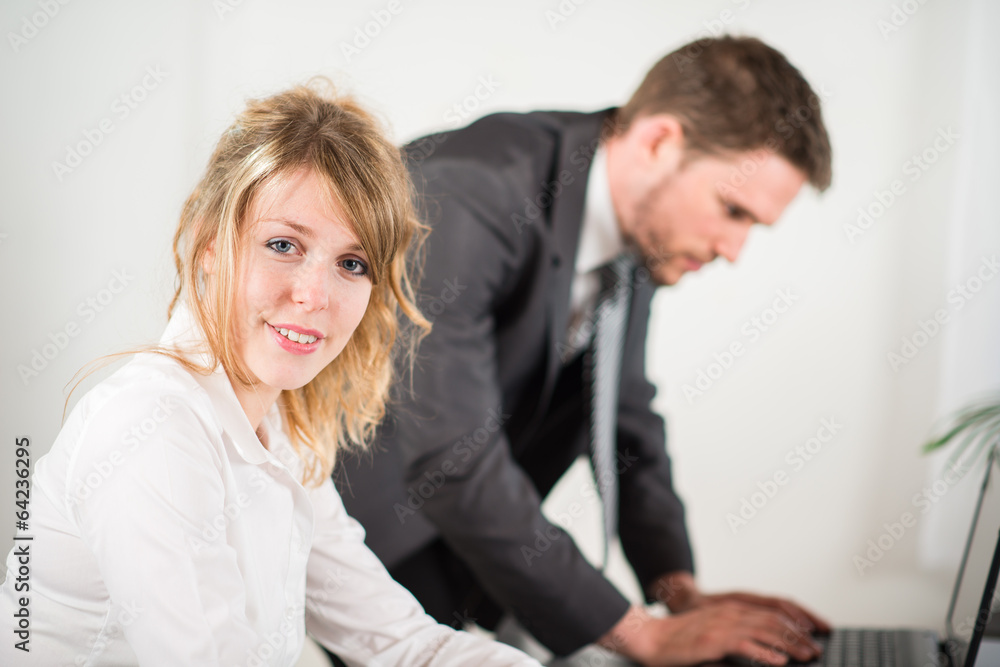 portrait of two business people working together in office portrait of two business people working together in office