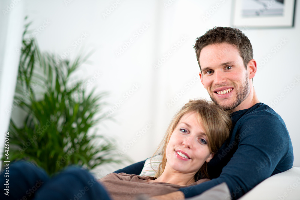 portrait of a cheerful young couple relaxed at home portrait of a cheerful young couple relaxed at home