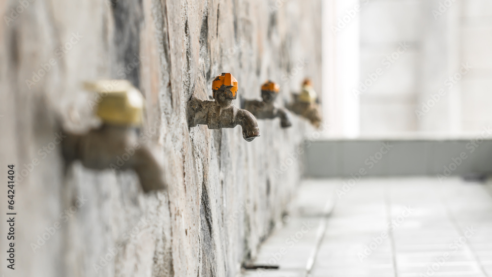 Old rusty water tap on concrete wall Old rusty water tap on concrete wall