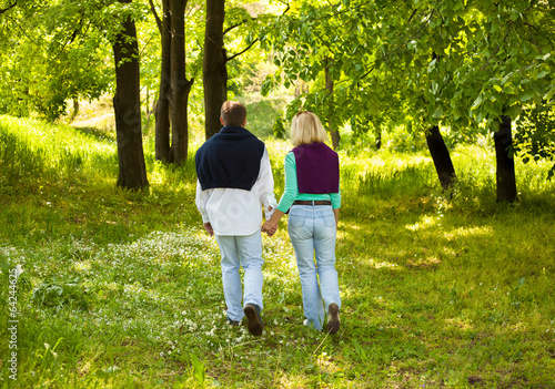 adult couple walking through forest