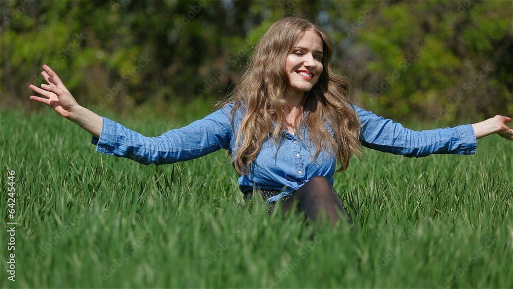 Pretty girl relaxing on a grass during spring time Pretty girl relaxing on a grass during spring time