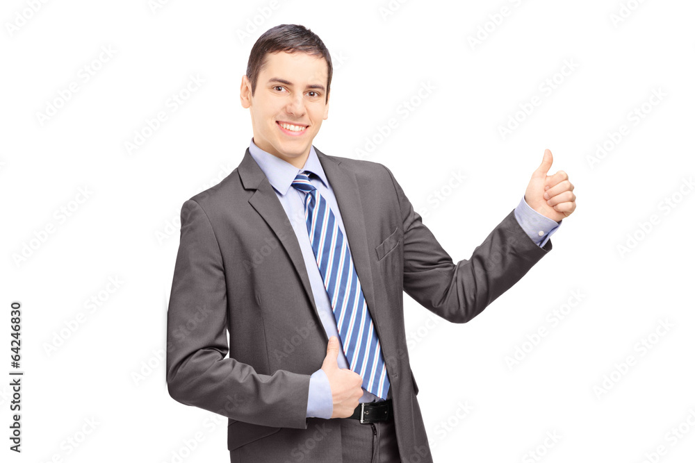 Businessman leaning against wall and giving thumb up Businessman leaning against wall and giving thumb up