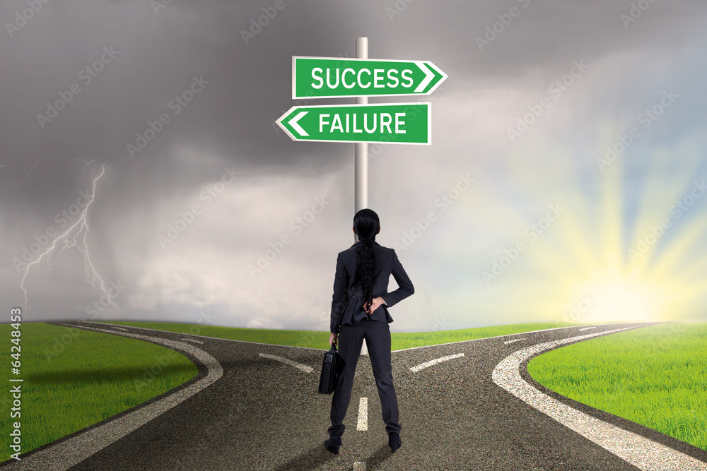 Businesswoman looking at sign of success or failure Businesswoman looking at sign of success or failure