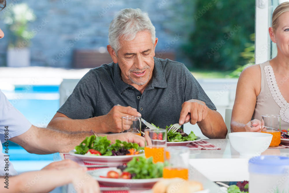mature man with family dinner table mature man with family dinner table