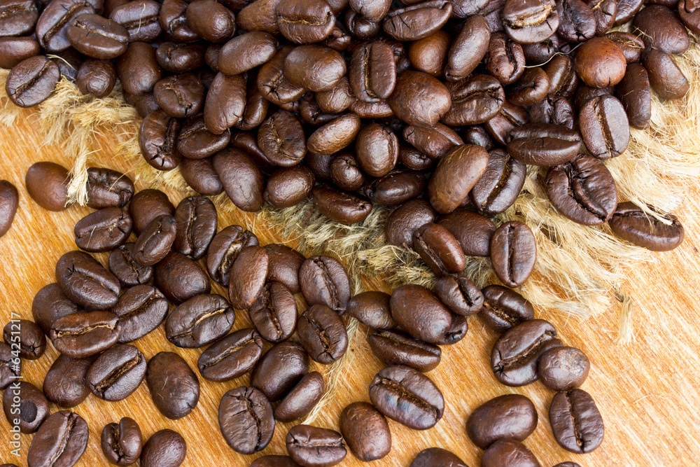 Fresh coffee beans on wood background Fresh coffee beans on wood background