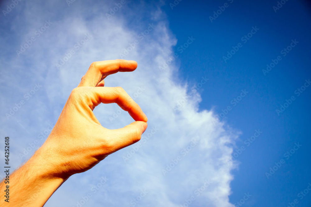 Delicious Hand Symbol on Blue Sky with Cloud Photo Delicious Hand Symbol on Blue Sky with Cloud Photo