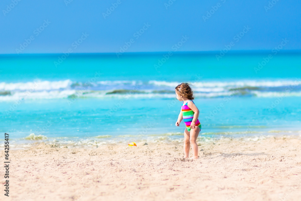 Toddler girl playing on a beach