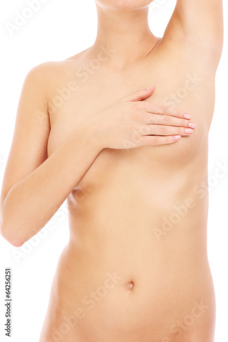 Naked woman checking her breast