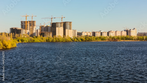 Building of city habitation on bank big river