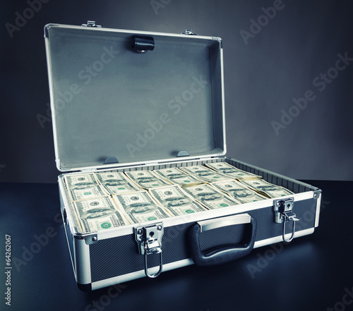 Fotografía Case full of money on gray background