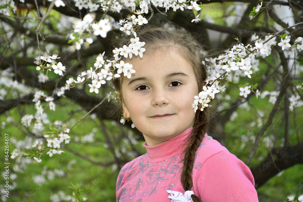 Spring in the garden a little girl holding a cherry branch. Spring in the garden a little girl holding a cherry branch.