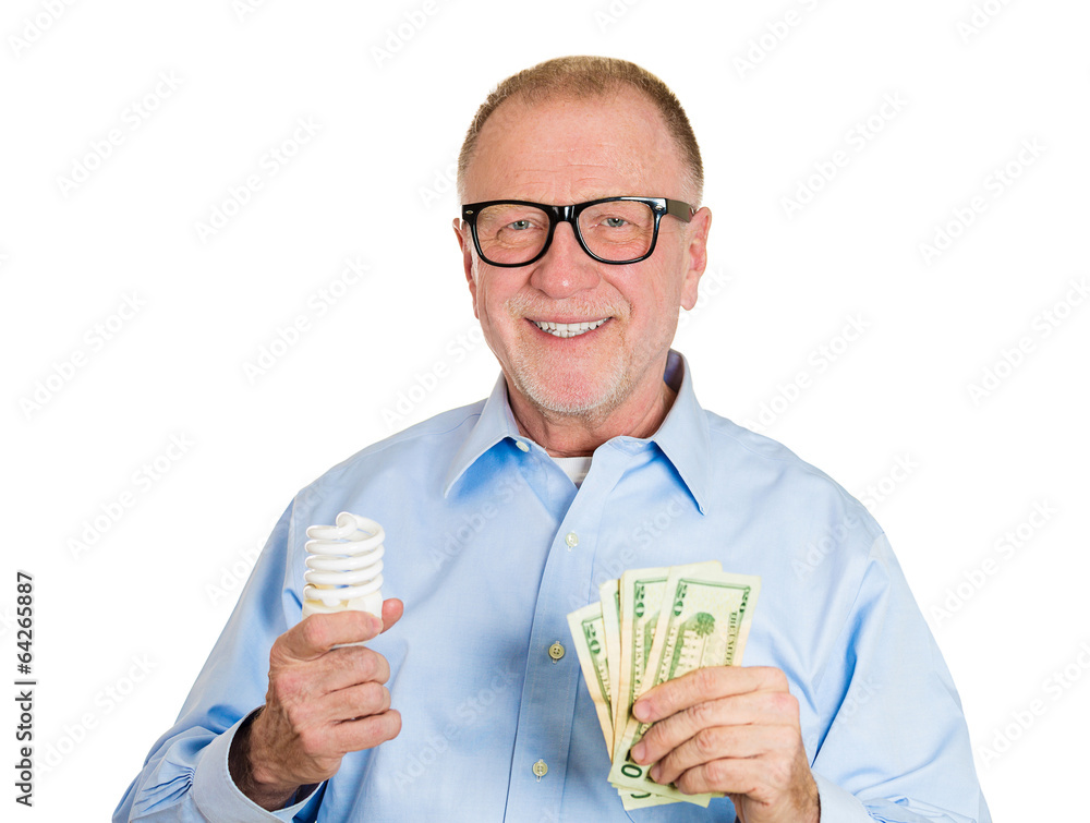 Energy watt savings. Senior man holding energy saving light bulb Energy watt savings. Senior man holding energy saving light bulb