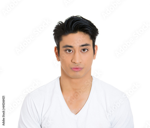 Serious headshot of annoyed grumpy young man white background 