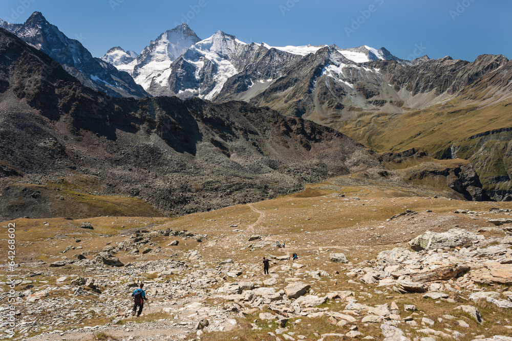 hikers descending in Val d'Anniviers in Swiss Alps