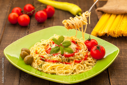 fork full of spaghetti with cheese and tomato sauce photo