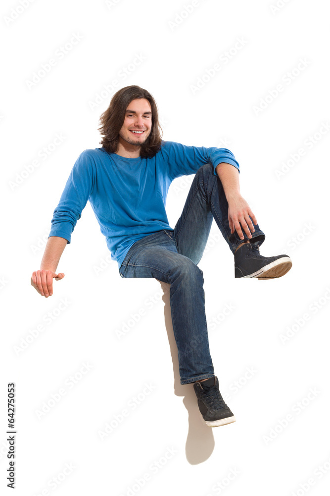 Relaxed man sitting on a banner