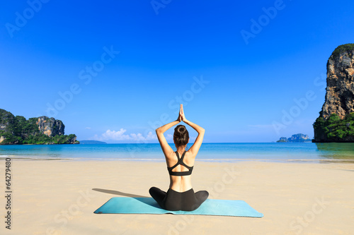 Yoga woman on sea coast