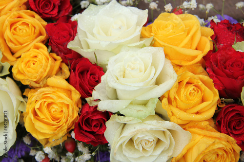 yellow  white and red roses in a wedding arrangement