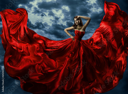 Woman in red evening dress, waving gown with flying long fabric