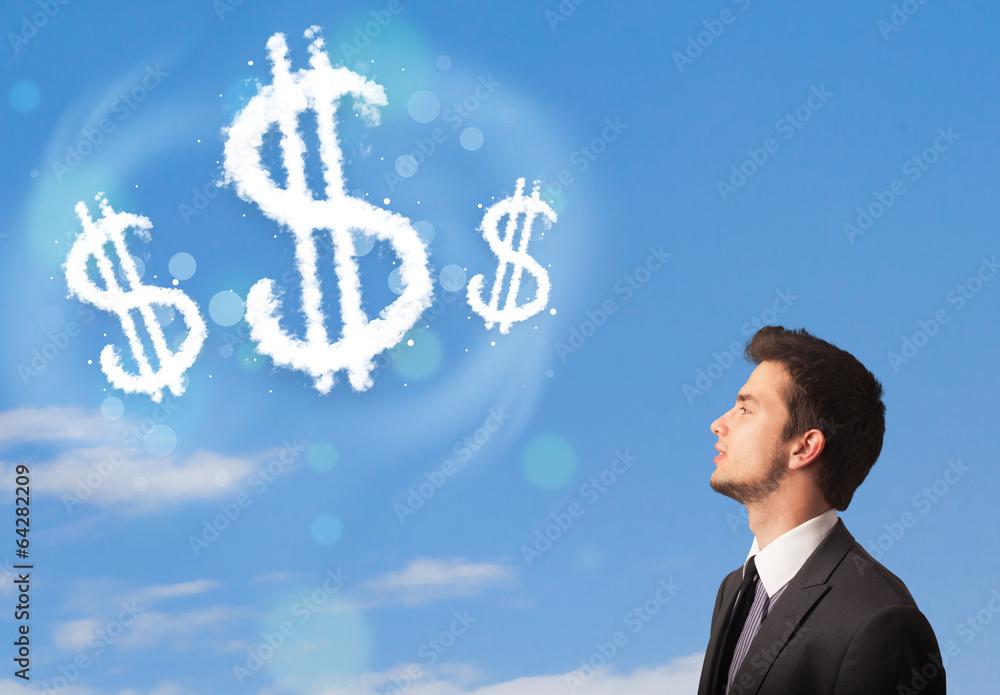 Businesman pointing at dollar sign clouds on blue sky