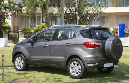 New 5 door saloon car parked outside an apartment